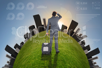 Young businessman standing with suitcase