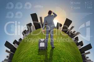 Young businessman standing with suitcase