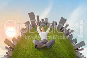 Cheering businesswoman sitting cross legged