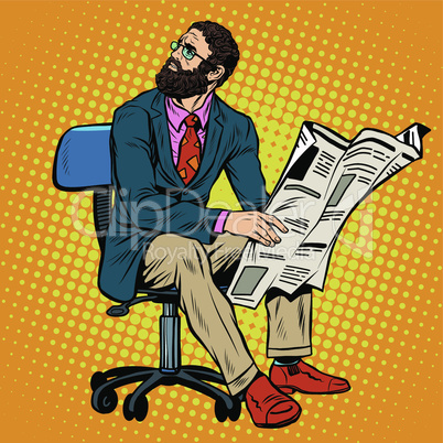 Bearded businessman reading a newspaper