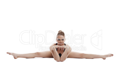 Nice woman posing while doing gymnastic split