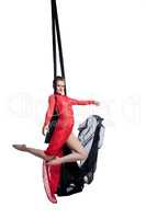 Beautiful female dancer posing on aerial silks