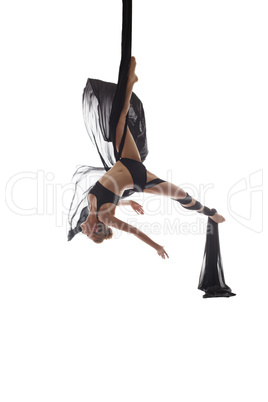 Aerial silks. Flexible dancer posing upside down