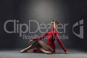 Graceful red-haired dancer froze in pose