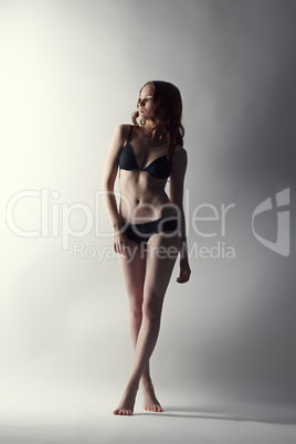 Studio shot of leggy model posing in lingerie