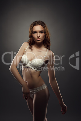 Brown-haired girl posing gracefully in lingerie