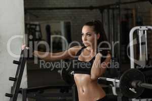 Gym. Beautiful woman posing sweaty after workout