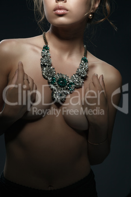 Necklace on neck of topless girl with perfect body