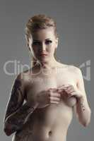 Image of attractive naked woman with tattoos