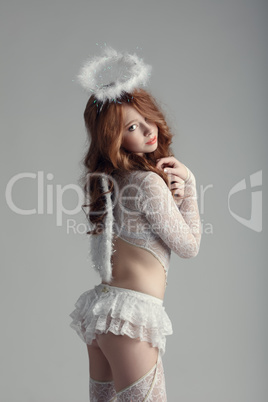 Innocence and sexuality. Girl in angel costume