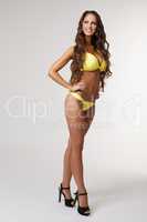 Happy tanned model advertises stylish swimsuit
