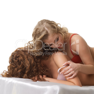 Forbidden love concept. Curly girls hugging in bed