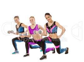 Training with dumbbells. Shot of cute girls posing