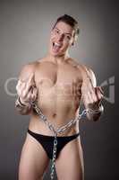 Seminude man in handcuffs showing obscene gestures