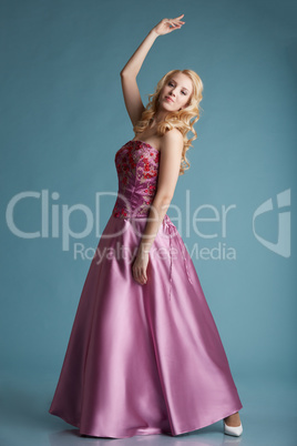 Pretty blonde girl posing in dress for prom