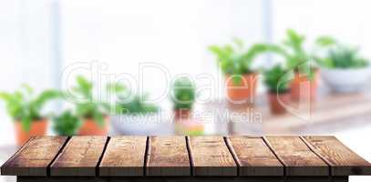 Composite image of green plan on table with book