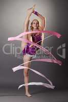 Shot of flexible young gymnast dancing with ribbon