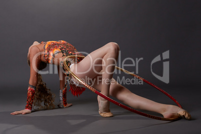 Graceful artistic gymnast performs with hoop