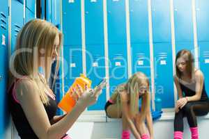 Before training. Sexy girls resting in locker room