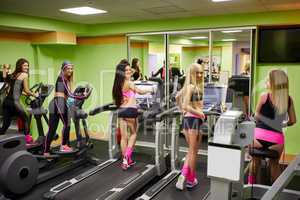 Cheerful sporty girls exercising in gym