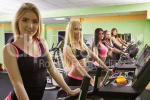 Group of lovely athletes exercising at gym
