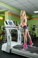 Fitness center. Image of blonde on treadmill
