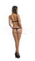 Rear view of skinny woman posing in lingerie