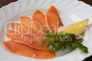 Restaurant food. Sliced salmon with lemon