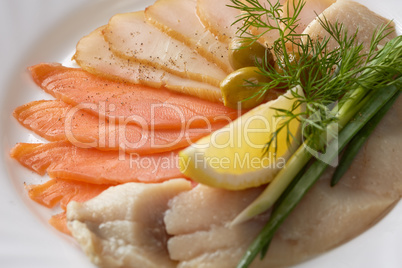 Close-up of delicious fish slicing with greenery