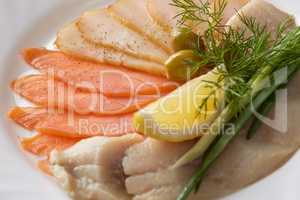 Close-up of delicious fish slicing with greenery