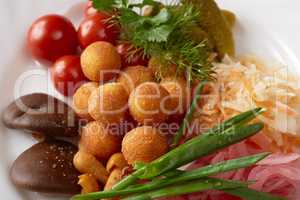 Close-up of cheese balls and pickled vegetables