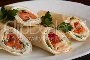 Delicious rolls of pita with salmon and red caviar