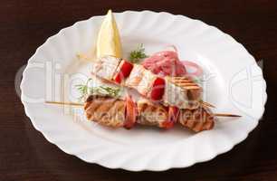 Skewers of grilled fish and vegetables, close-up