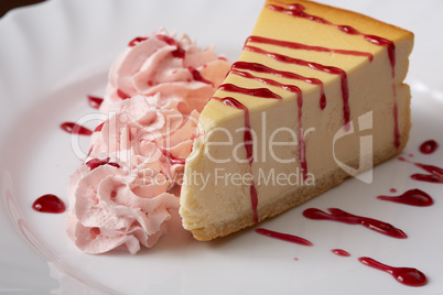 Tasty cheesecake with raspberry cream and syrup Tasty cheesecake with raspberry cream and syrup