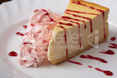 Tasty cheesecake with raspberry cream and syrup