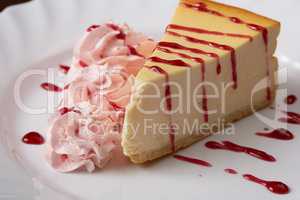 Tasty cheesecake with raspberry cream and syrup