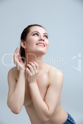 Studio shot of happy woman posing nude to waist