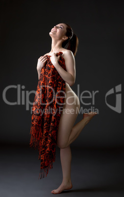 Cheerful nude woman covers her body with cloth
