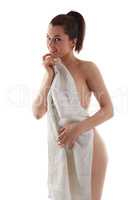 Playful naked woman posing hiding behind towel