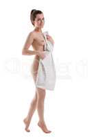 Body care. Smiling nude woman hiding behind towel