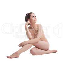 Pretty woman posing nude in body treatment