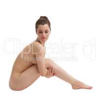 Attractive nude woman posing hugged her legs
