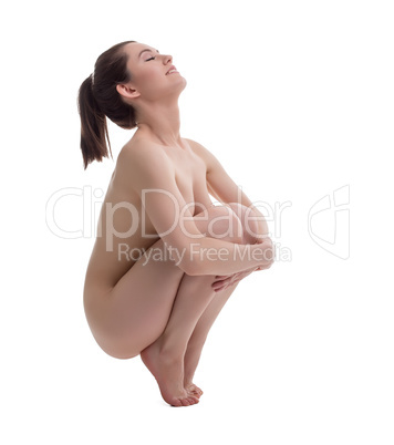 Nude woman engaged in pilates, isolated on white