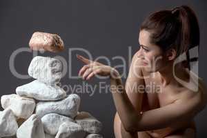 Naked girl moves stone without touching it