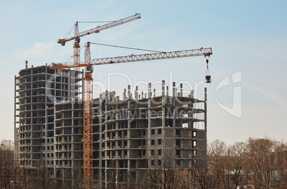 Image of building under construction and cranes