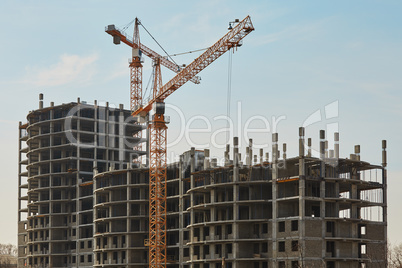 Building construction site with cranes under sky