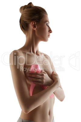 Woman with pink breast cancer awareness ribbon
