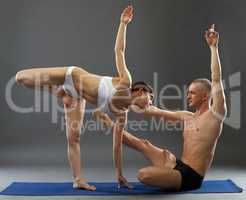 Paired yoga. Image of people exercising in studio