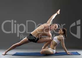 Studio shot of paired yoga, on gray background