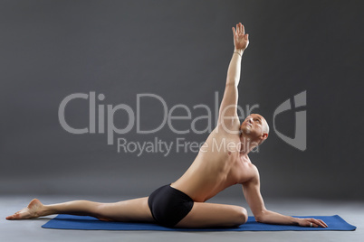 Studio shot of middle-aged man practicing yoga